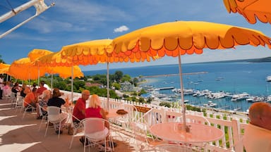 Mackinac Island showing general coastal views, outdoor eating and a marina