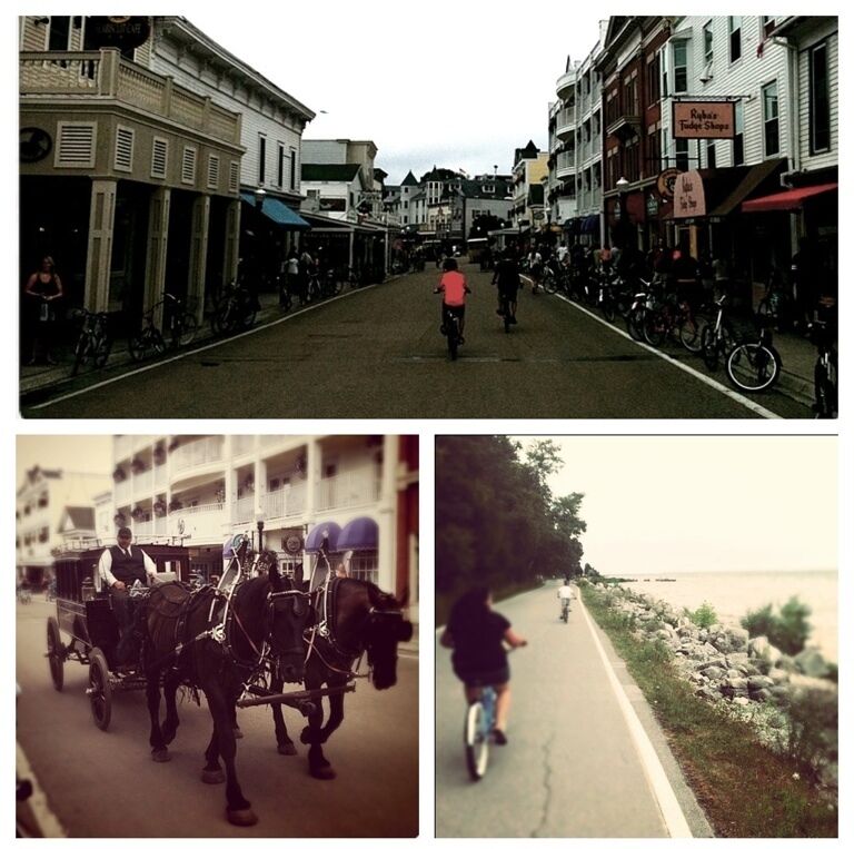 Una calle con edificios, un carruaje tirado por caballos y un ciclista.