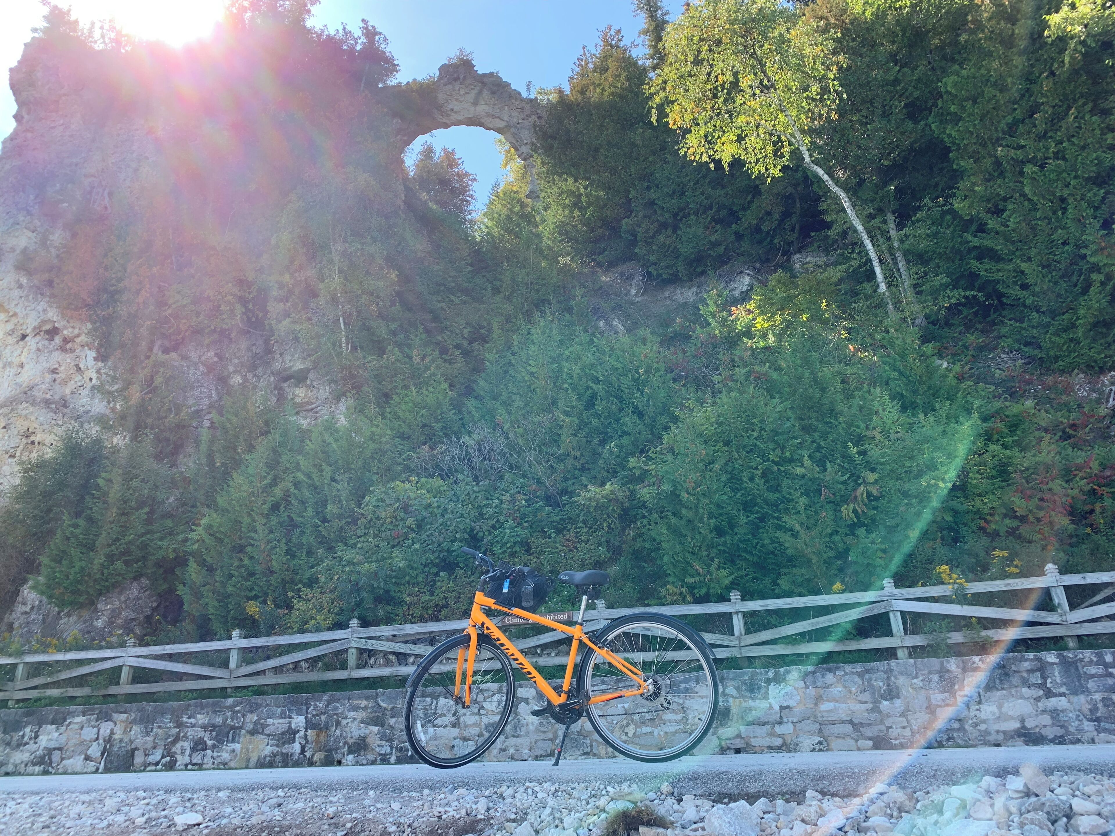 Arch rock with the sun setting behind it. 
#LifeAtExpediaGroup