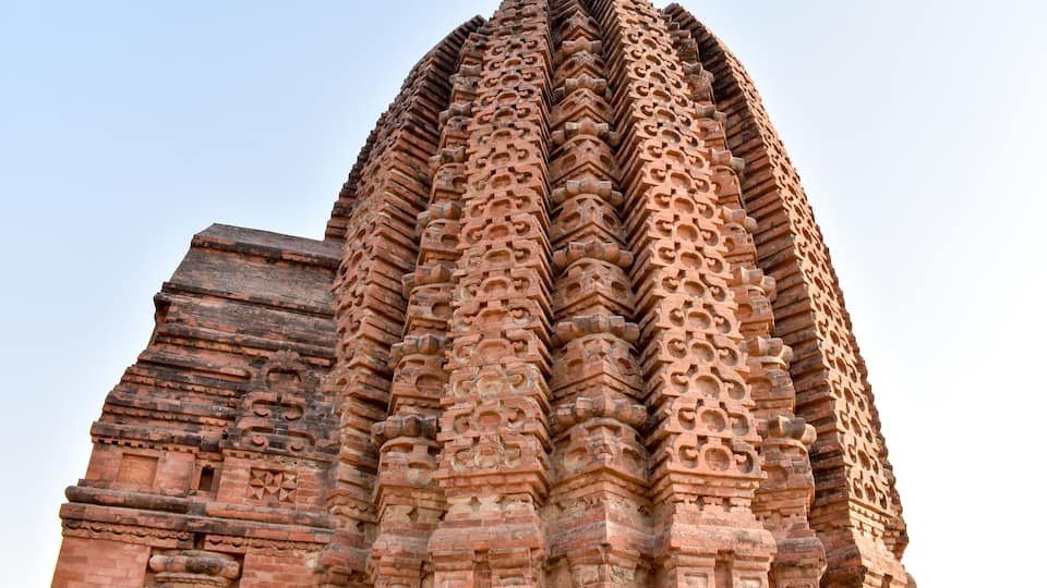 A large, intricately carved temple with multiple tiers and detailed stonework.