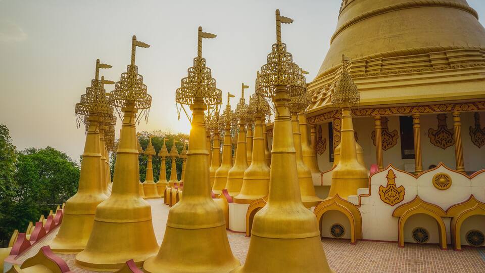 A temple with golden spires and a large dome.
