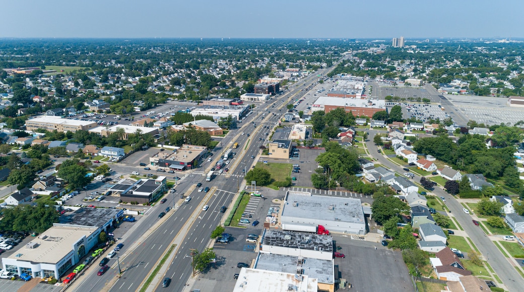 Aerial View of Hempstead Turnpike in Levittown, NY Which is a Busy Urban Area With Shopping Centers and Residential Homes on a Clear Day