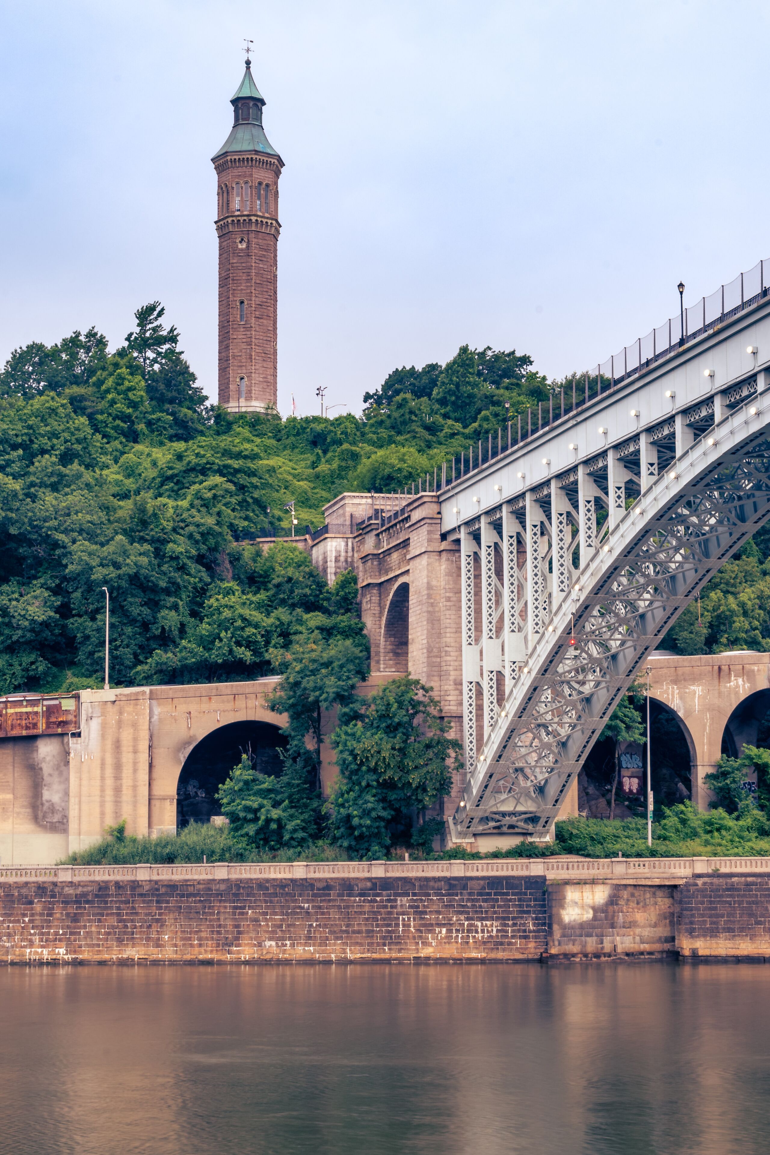 A bridge with a tower in the background.
