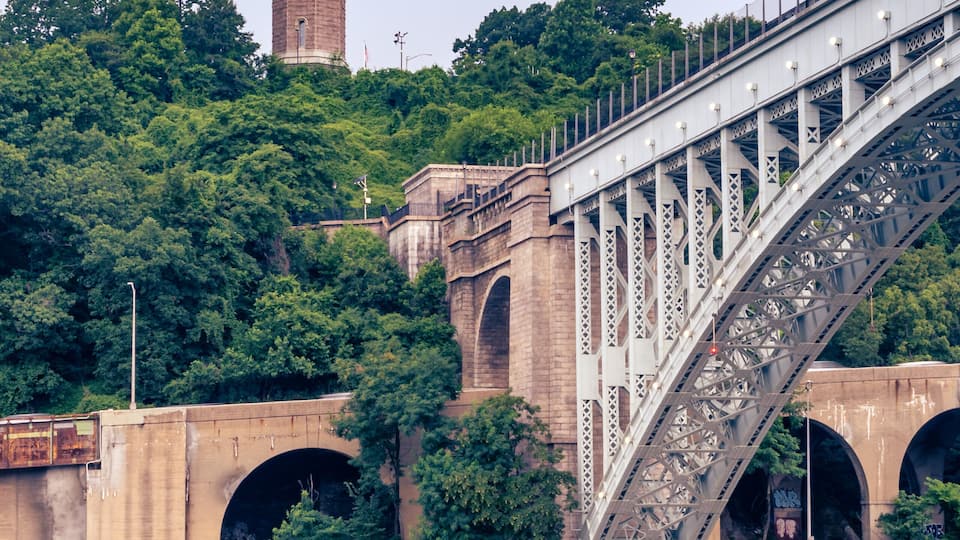 A bridge with a tower in the background.