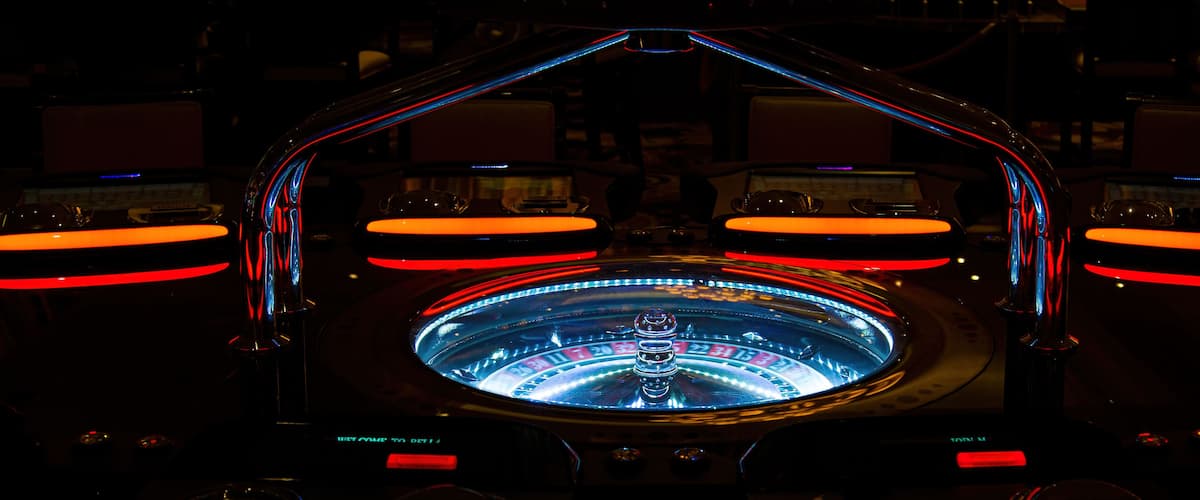 A roulette wheel with illuminated numbers and a central zero.