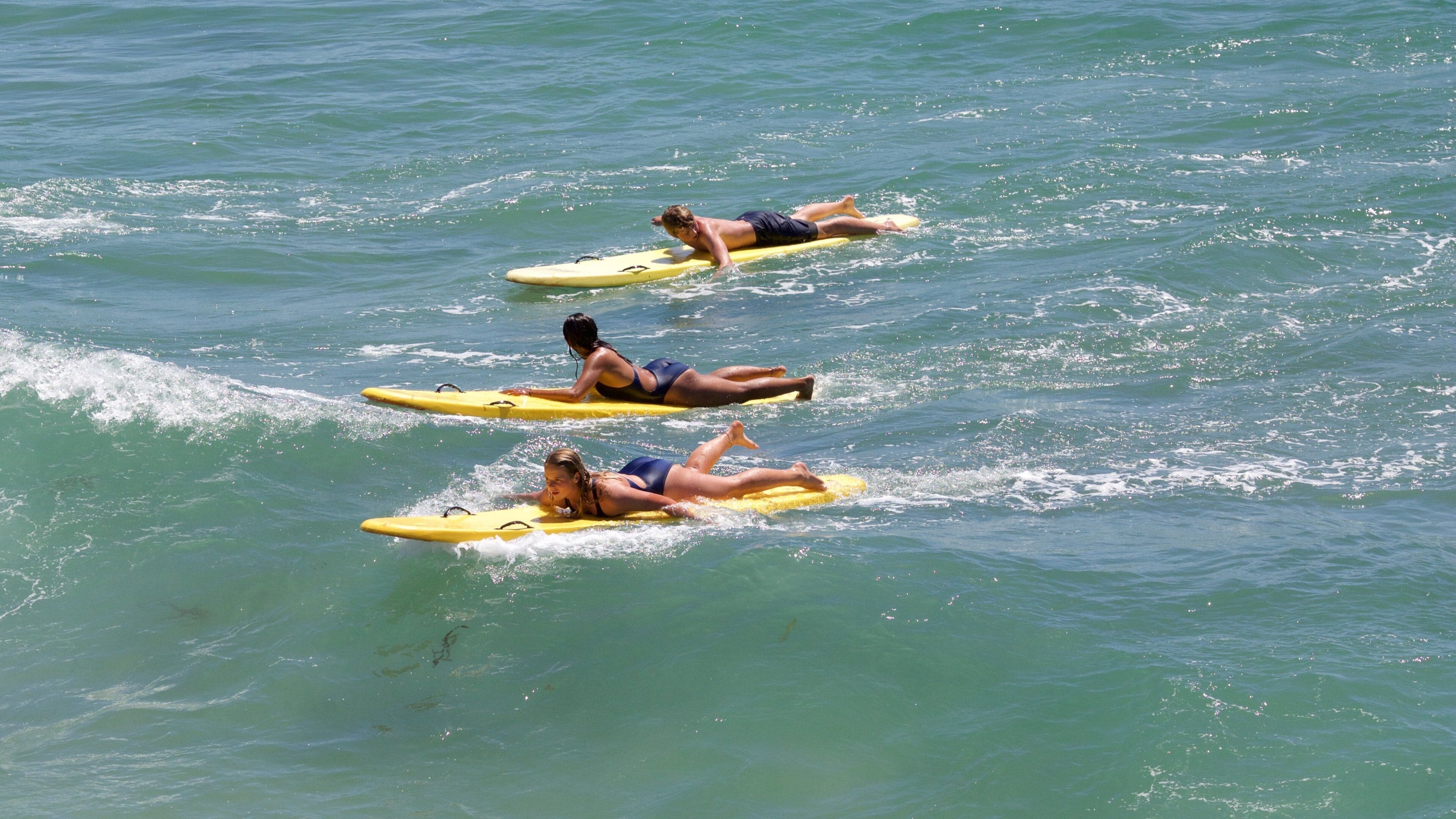 Hermosa Beach which includes a beach and surfing as well as a small group of people