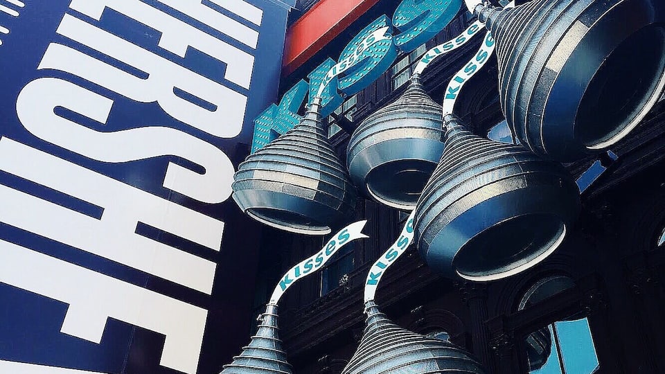 A building with large, metallic, conical structures and a prominent Hershey sign.