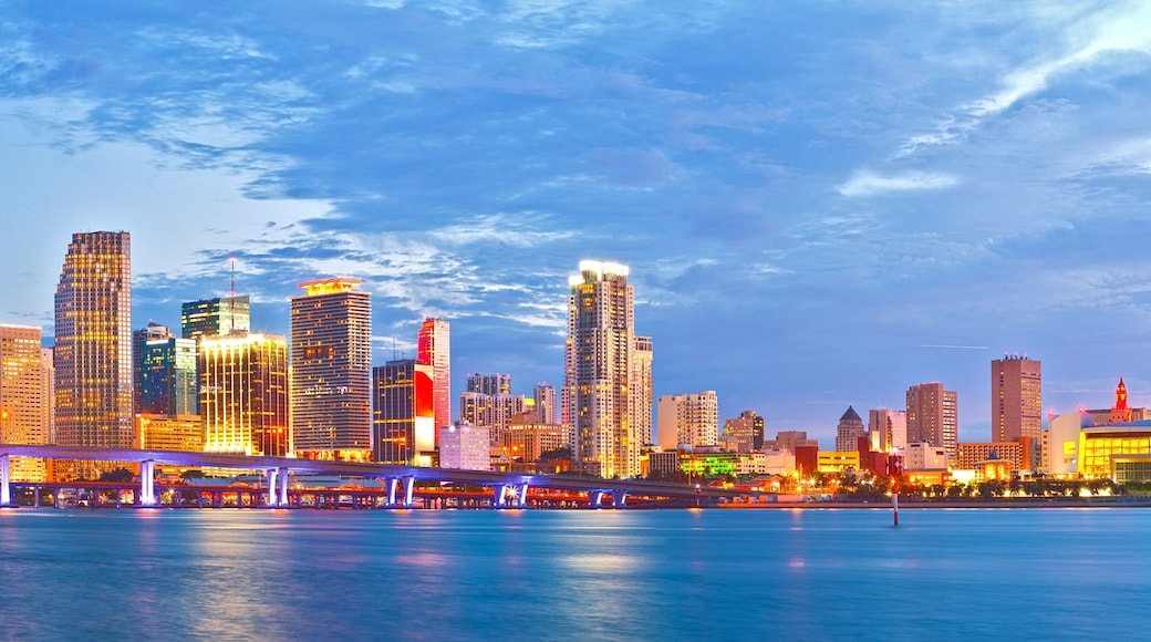 Miami Florida at sunset, cityscape of modern downtown buildings illuminated with reflections in the waters of Biscayne BAy