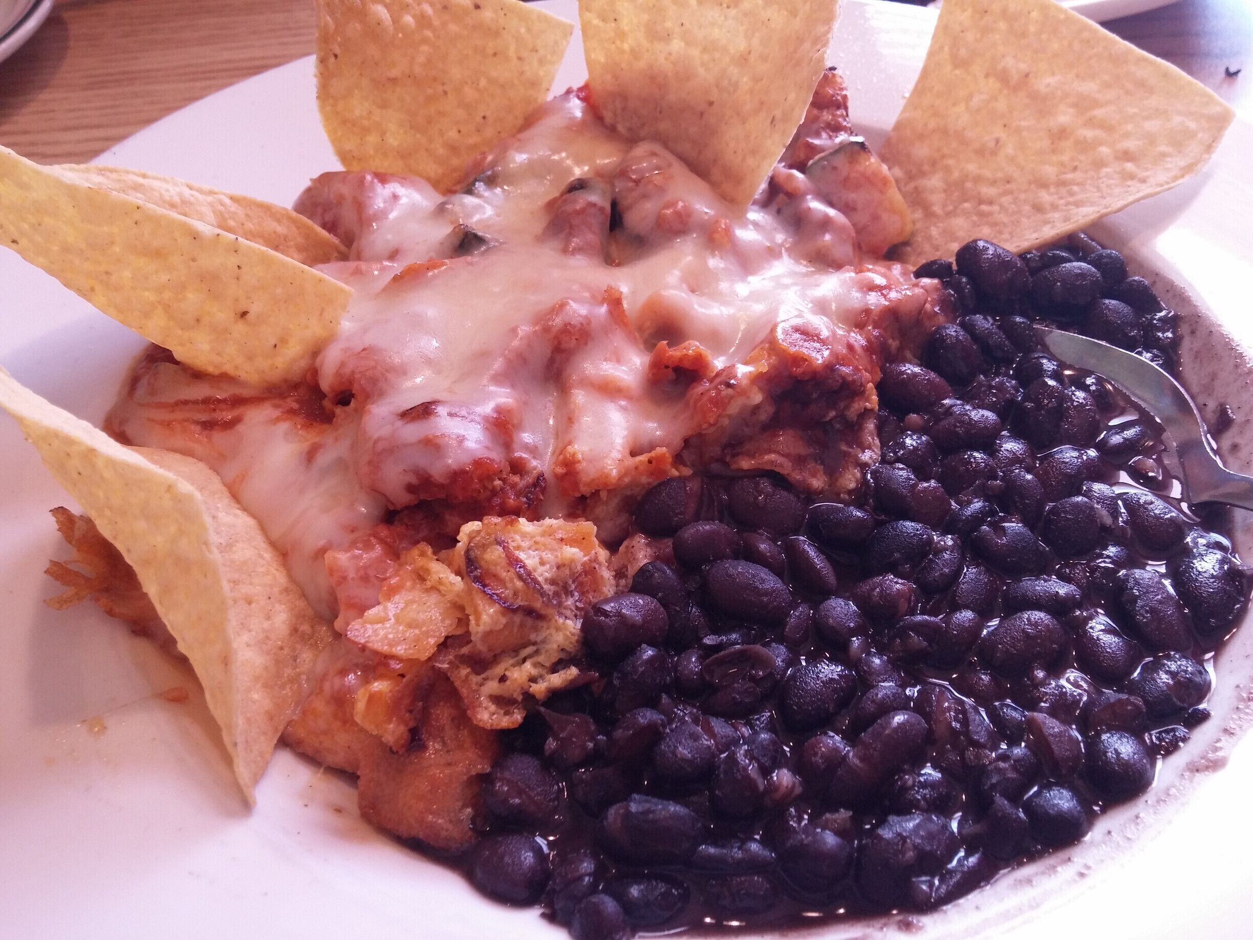 Tex-Mex style Chilaquiles - three scrambled eggs with chorizo, poblano peppers, onions, zucchini, corn, jack cheese and chipotle sauce. Served with corn tortilla chips and black beans.

Quite an eclectic menu with Cuban, Cajun, Mexican, American and Italian offerings.