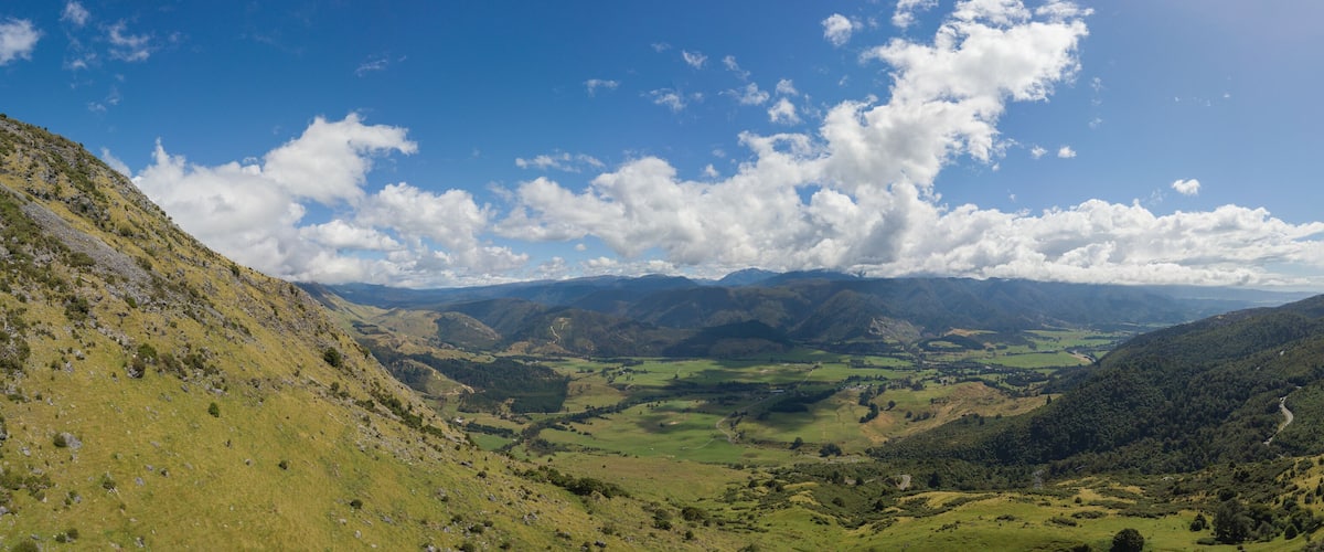 A valley with rolling hills and a winding road.
