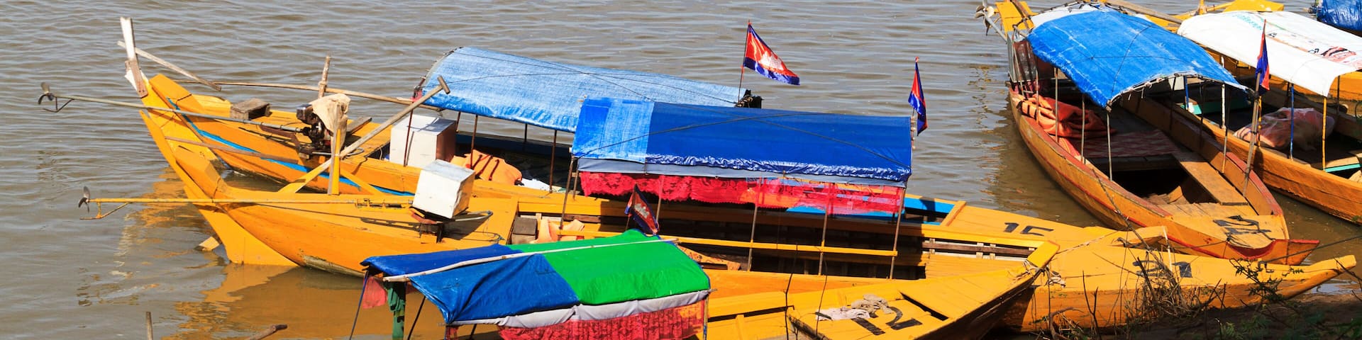 Kratie, Cambodia. Tour sampans waiting to to take people to see the rare freshwater Irrawaddy dolphins.