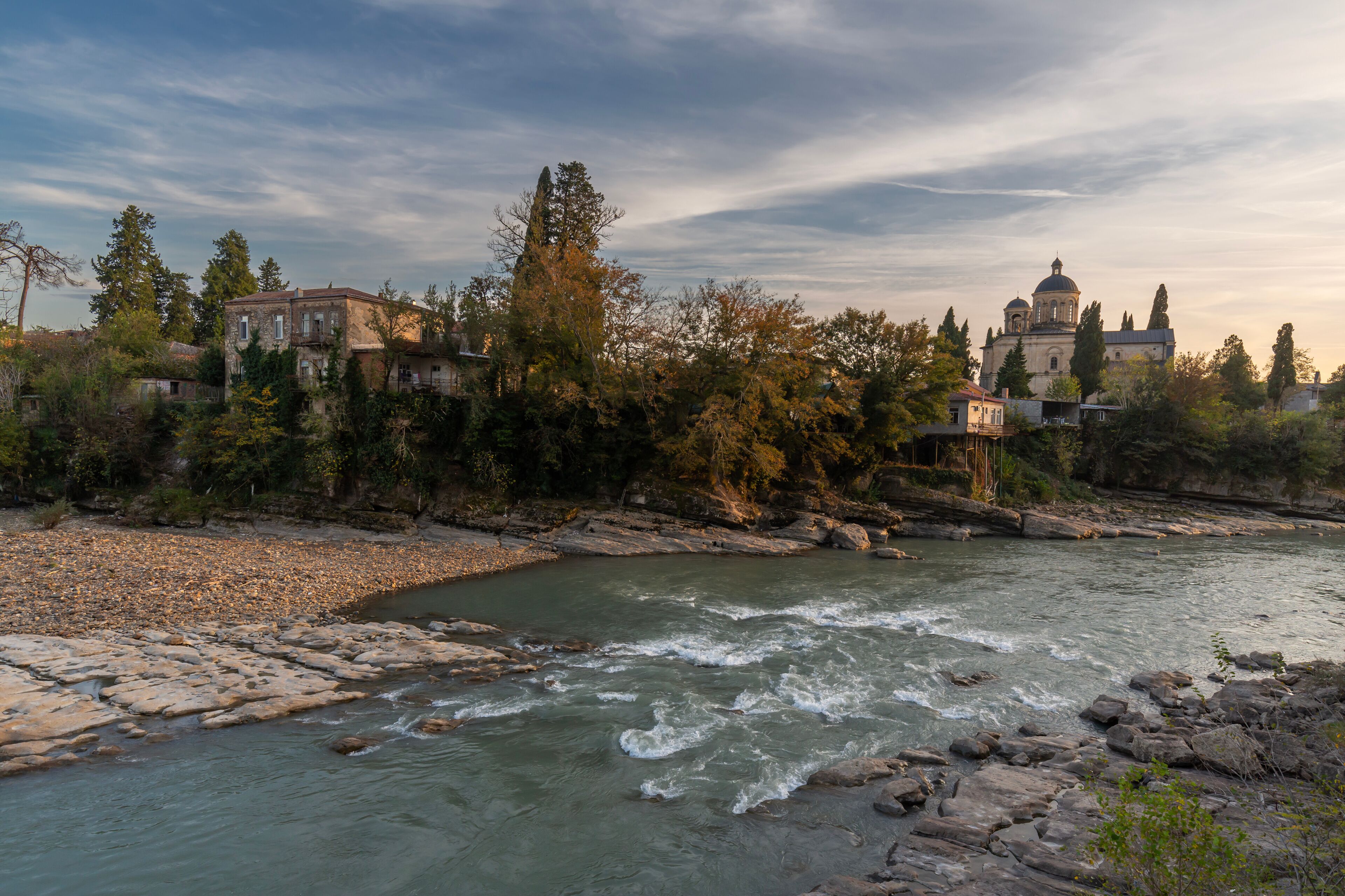 The Rioni River embankment in the city Kutaisi, Georgia. Sunset cityscape