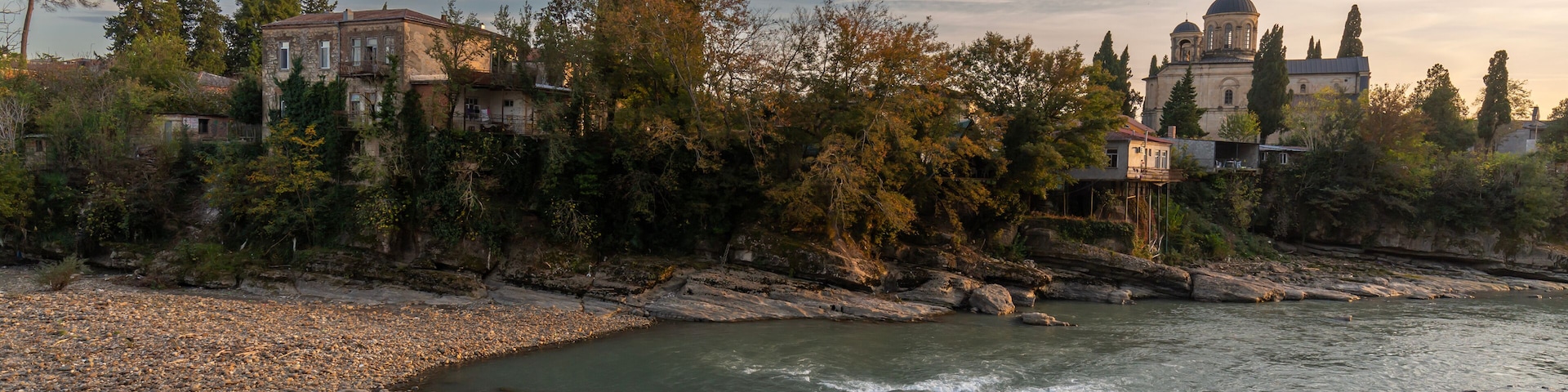 The Rioni River embankment in the city Kutaisi, Georgia. Sunset cityscape
