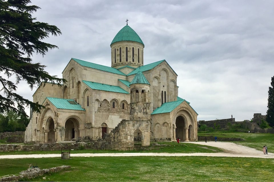 A historic church with a green dome and multiple arched windows.
