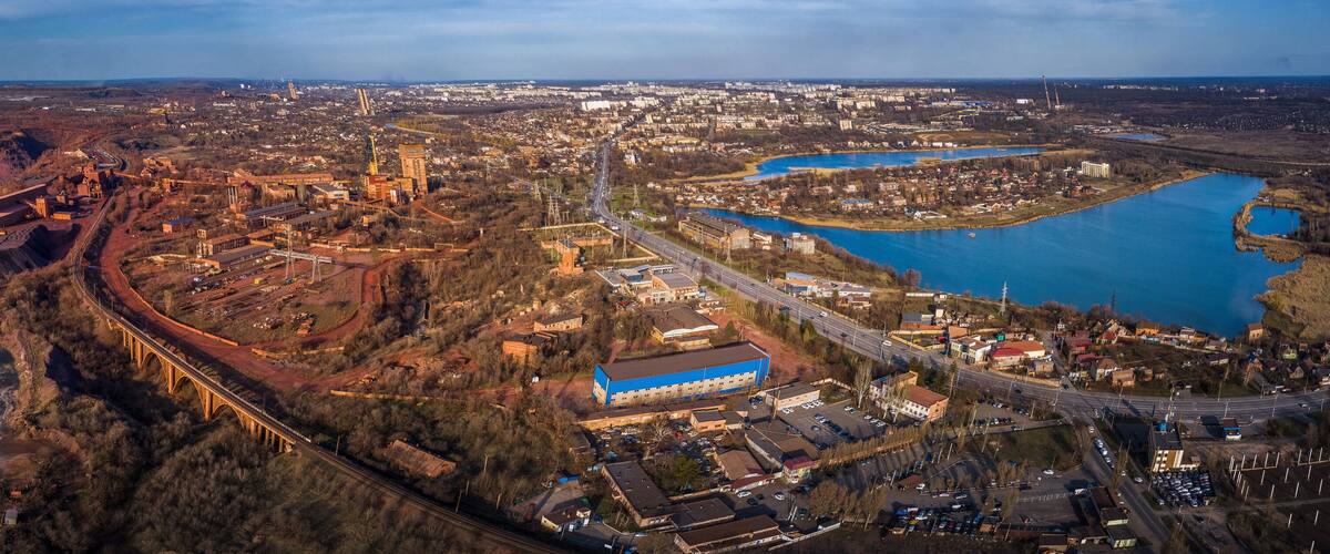 An aerial view of a mining area with a bridge, a river, and a town.