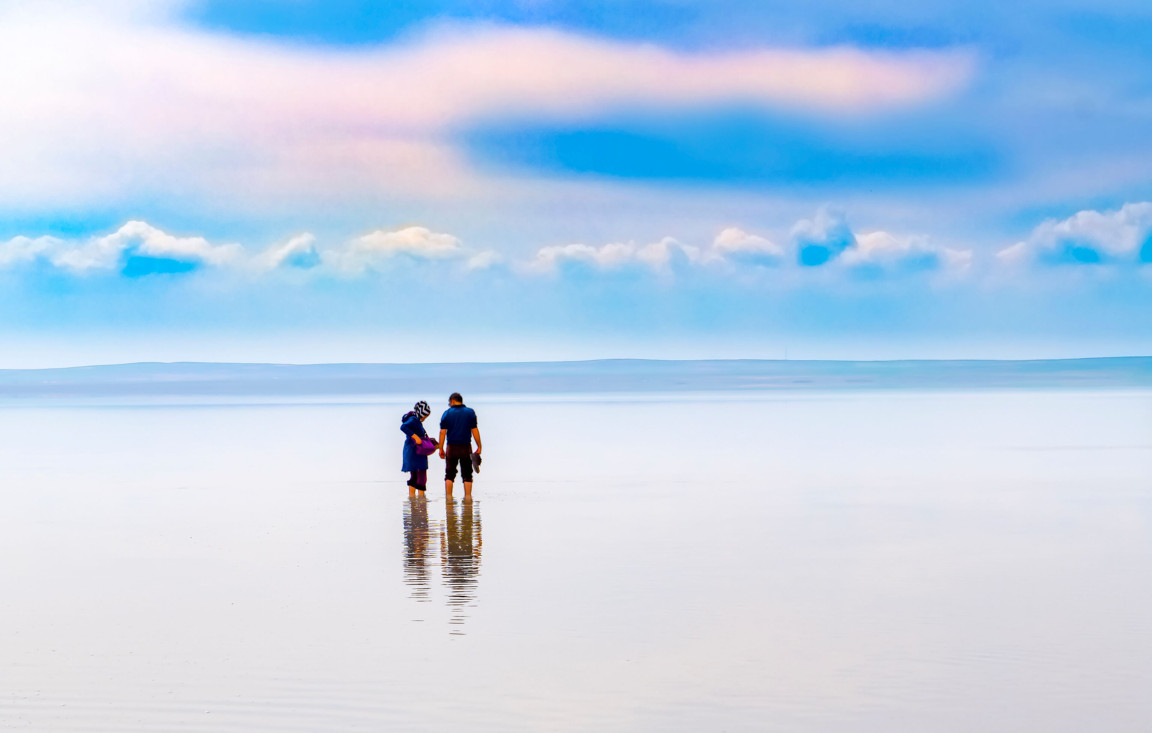 Silhouette of couple walking on the famous tourist destination Salt Lake (Turkish: Tuz Golu ) is the second largest lake in Turkey.