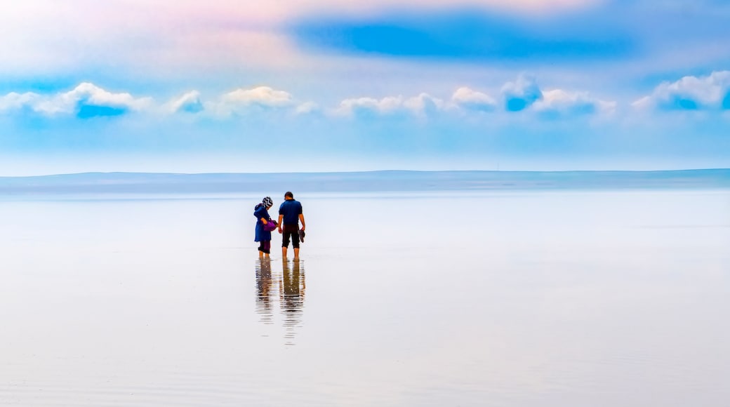 Silhouette of couple walking on the famous tourist destination Salt Lake (Turkish: Tuz Golu ) is the second largest lake in Turkey.
