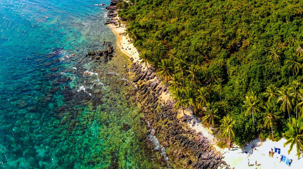 Aerial view of beautiful landscape, tourism boats, and people swimming on the sea and beach on May Rut island (a tranquil island with beautiful beach) in Phu Quoc, Kien Giang, Vietnam.