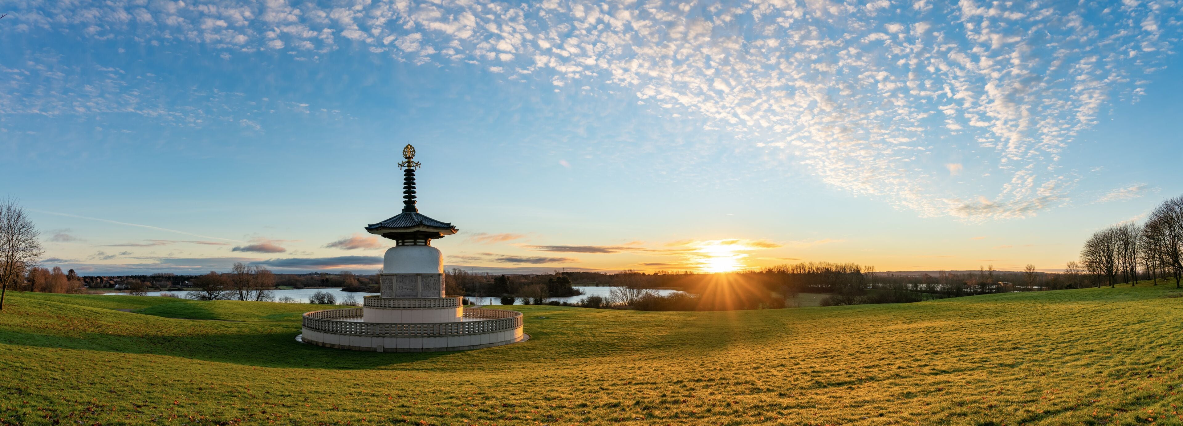 Panorama of Peace Pagoda temple at sunrise in Willen Park, Milton Keynes, UK