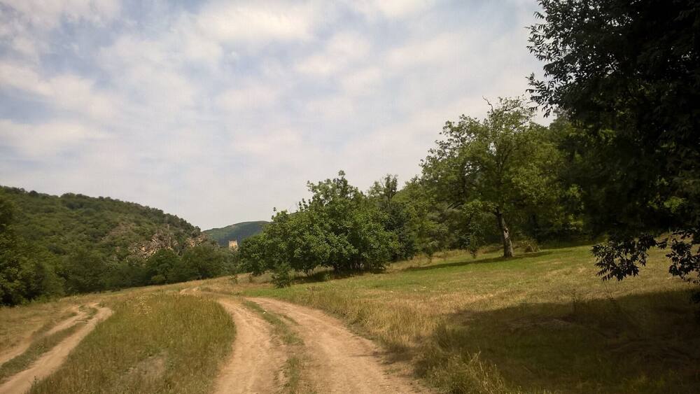 Driving down a dirt road, an old fortress called Kuhluti is visible in the distance.
View from rural Kvemo Kartli in the country of Georgia.