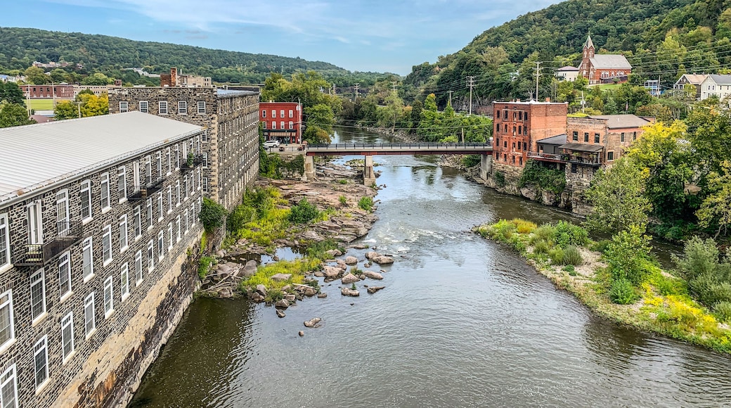A river flowing through a town with stone buildings and a bridge.
