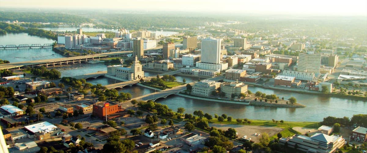 A cityscape with a river, bridges, and various buildings.