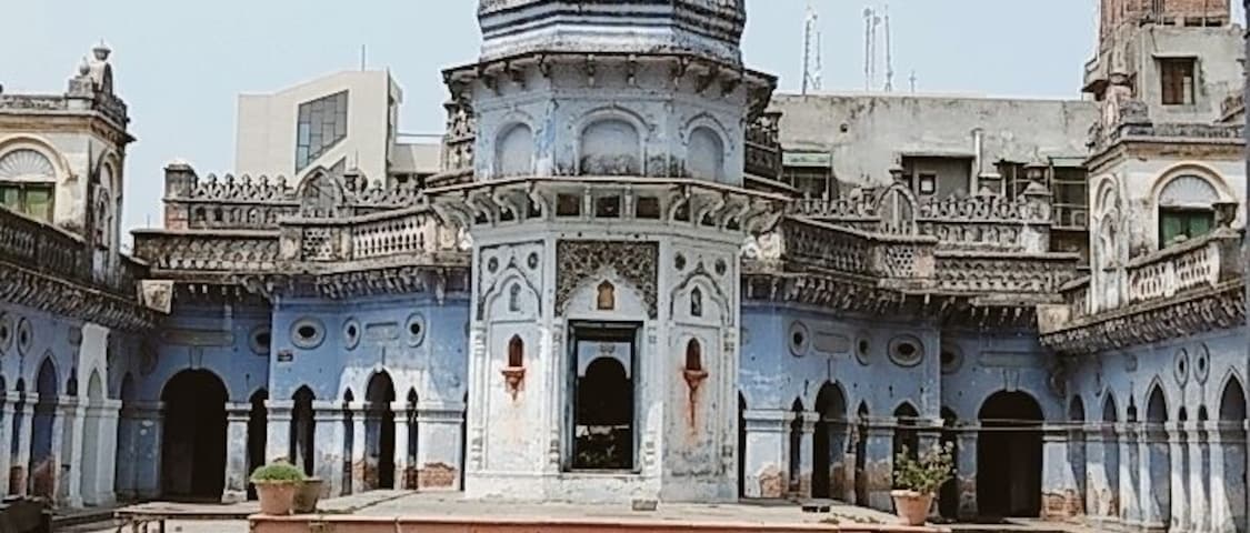 A historic building with a central dome and a courtyard.