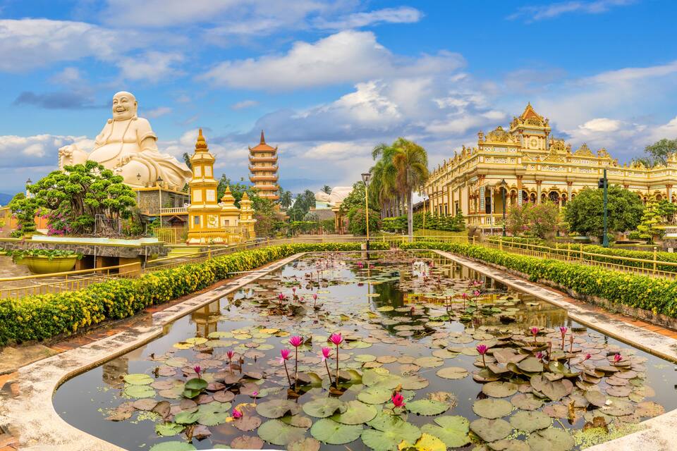 A temple complex with lotus ponds and golden architecture.
