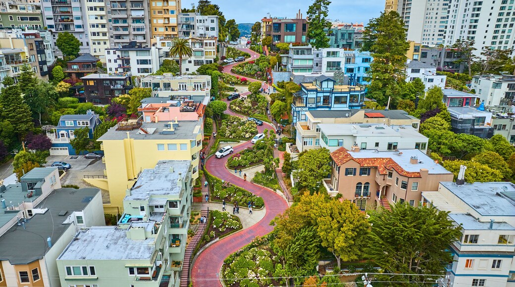Gorgeous wider aerial of iconic Lombard Street with buildings on either side of red brick road