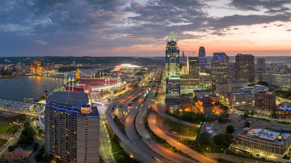 Cincinnati Ohio urban architecture in city downtown at night. Panoramic view of business district skyline with high-rise buildings at nightfall
