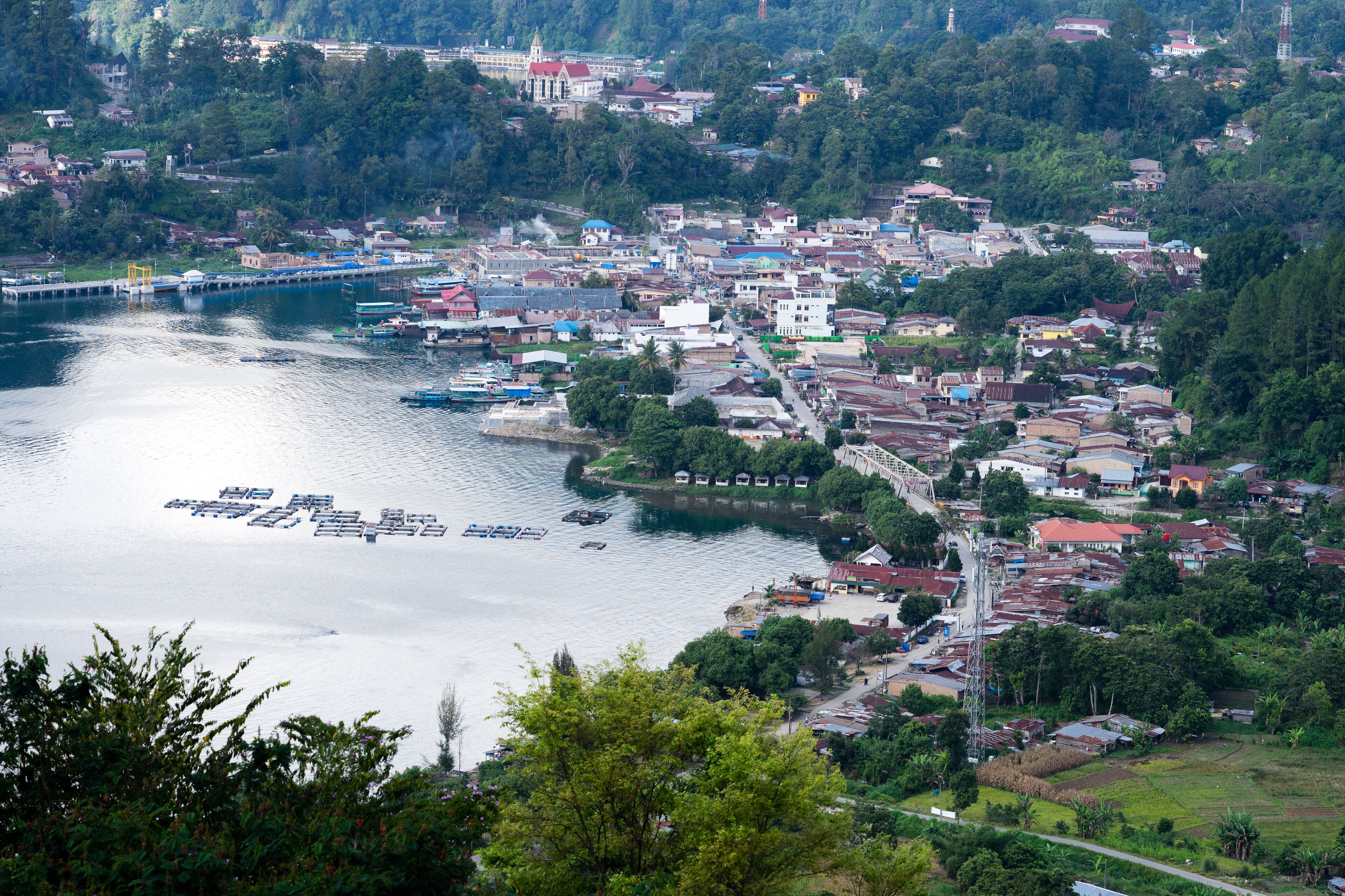 A coastal town with a river, boats, and a bridge.