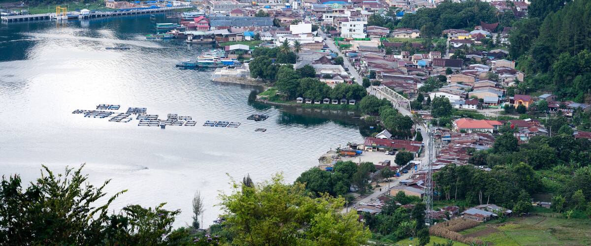 A coastal town with a river, boats, and a bridge.