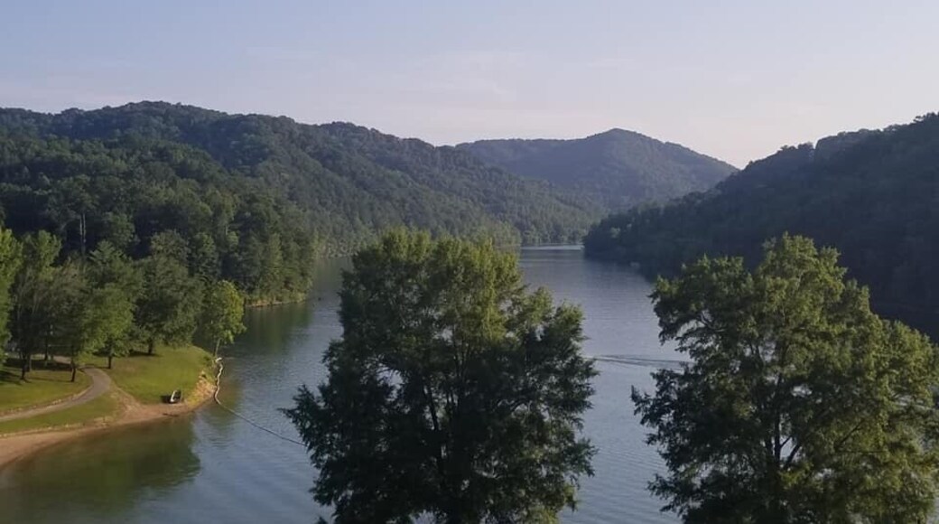 Long before Buckhorn Lake was created and the state park established in 1964, a small community flourished for many generations here, along the middle fork of the Kentucky River.
Early records refer to this area as the Bowling District, founded by Reverend Jesse Boling, his wife Mary Pennington, Reverend Duff and 50 other families. They were led to this remote area under the guidance of Daniel Boone. By the late 1800's Bowlingtown was a thriving community of hundreds. There was a post office, school, churches, grocery, saw mill, blacksmith and the Frontier Nursing Service. Local officials included a sheriff, magistrate, justice of the peace, and tax commissioner. The citizens were primarily farmers and coal miners. They were known to be patriotic, honest, kind, and well-educated people.
In 1960, when the construction of Buckhorn Lake began, Bowlingtown had to be abandoned and families relocated. Family graves (873) were re-interred to Buckhorn Cemetery. All were sad to leave their homeland of seven generations. so Where you see water was once The town called Bowlingtown in KY.