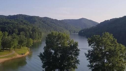 Long before Buckhorn Lake was created and the state park established in 1964, a small community flourished for many generations here, along the middle fork of the Kentucky River.
Early records refer to this area as the Bowling District, founded by Reverend Jesse Boling, his wife Mary Pennington, Reverend Duff and 50 other families. They were led to this remote area under the guidance of Daniel Boone. By the late 1800's Bowlingtown was a thriving community of hundreds. There was a post office, school, churches, grocery, saw mill, blacksmith and the Frontier Nursing Service. Local officials included a sheriff, magistrate, justice of the peace, and tax commissioner. The citizens were primarily farmers and coal miners. They were known to be patriotic, honest, kind, and well-educated people.
In 1960, when the construction of Buckhorn Lake began, Bowlingtown had to be abandoned and families relocated. Family graves (873) were re-interred to Buckhorn Cemetery. All were sad to leave their homeland of seven generations. so Where you see water was once The town called Bowlingtown in KY.