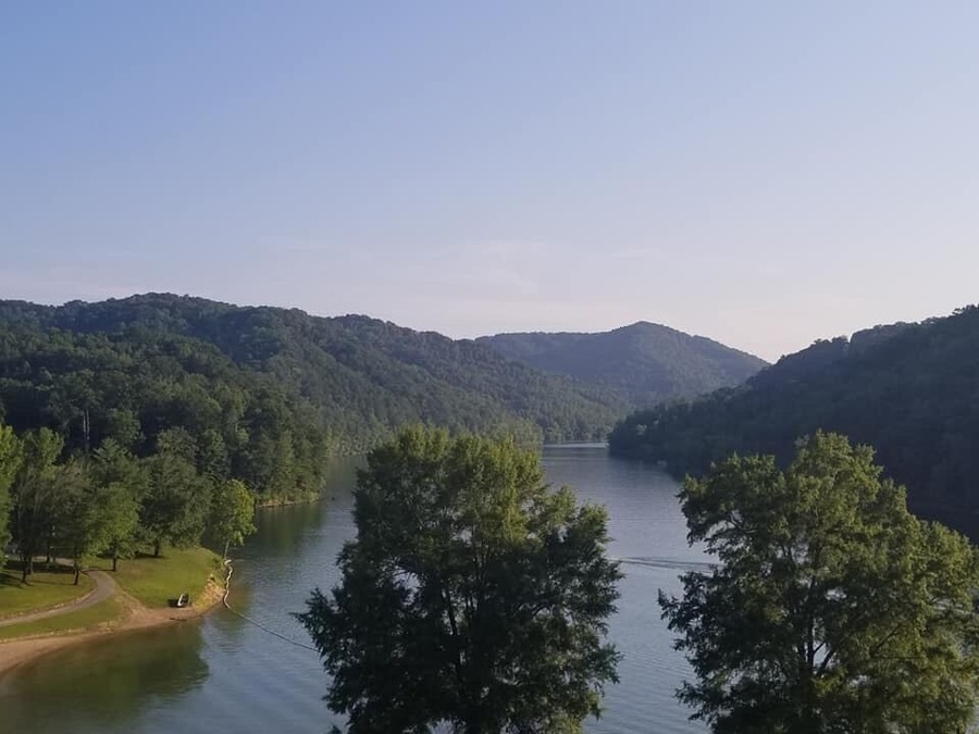 Long before Buckhorn Lake was created and the state park established in 1964, a small community flourished for many generations here, along the middle fork of the Kentucky River.
Early records refer to this area as the Bowling District, founded by Reverend Jesse Boling, his wife Mary Pennington, Reverend Duff and 50 other families. They were led to this remote area under the guidance of Daniel Boone. By the late 1800's Bowlingtown was a thriving community of hundreds. There was a post office, school, churches, grocery, saw mill, blacksmith and the Frontier Nursing Service. Local officials included a sheriff, magistrate, justice of the peace, and tax commissioner. The citizens were primarily farmers and coal miners. They were known to be patriotic, honest, kind, and well-educated people.
In 1960, when the construction of Buckhorn Lake began, Bowlingtown had to be abandoned and families relocated. Family graves (873) were re-interred to Buckhorn Cemetery. All were sad to leave their homeland of seven generations. so Where you see water was once The town called Bowlingtown in KY.