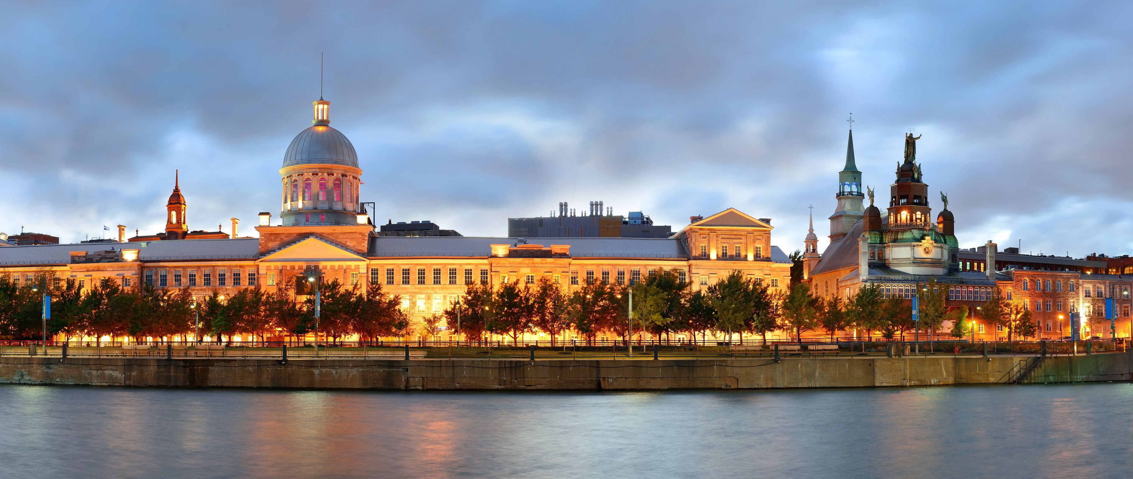 A historic building complex with a prominent dome and a statue.