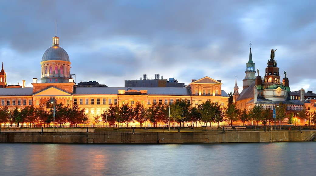 A historic building complex with a prominent dome and a statue.
