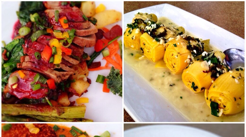 Southern American cuisine. Duck with pomegranate sauce, artichoke hearts, crab cakes and Galveston Pasta