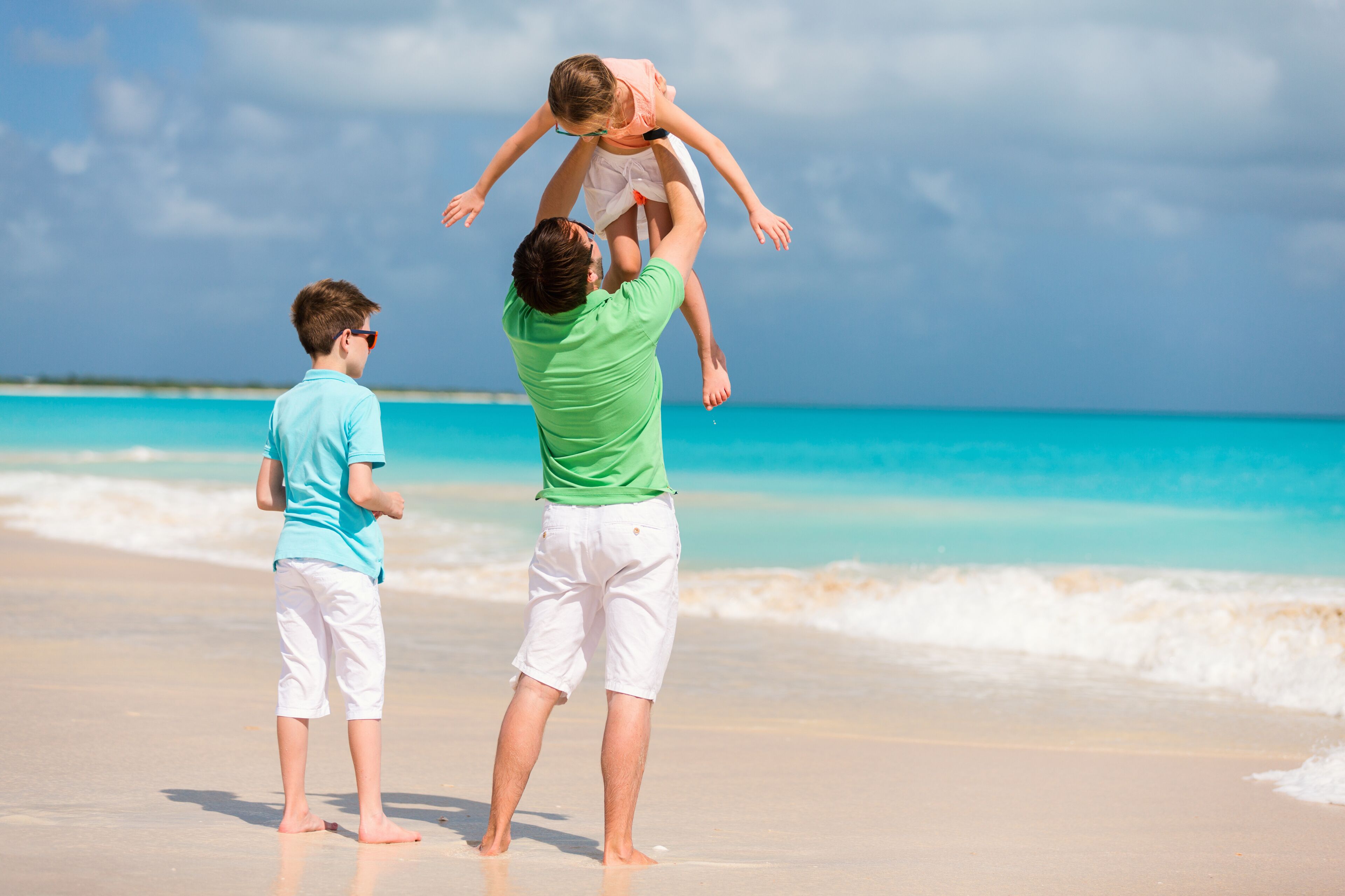 Father with kids at beach