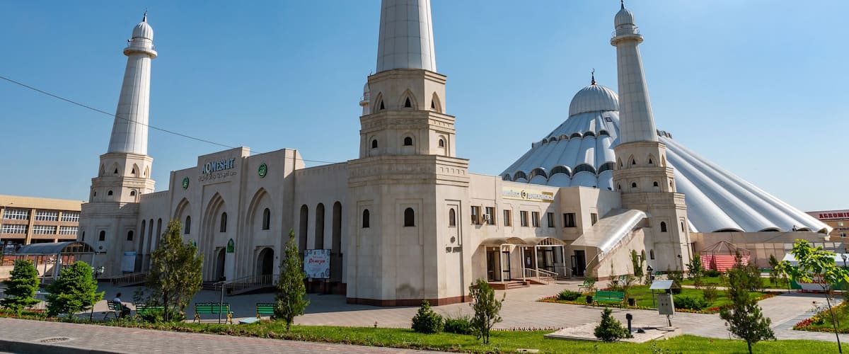 A mosque with two minarets and a large dome.
