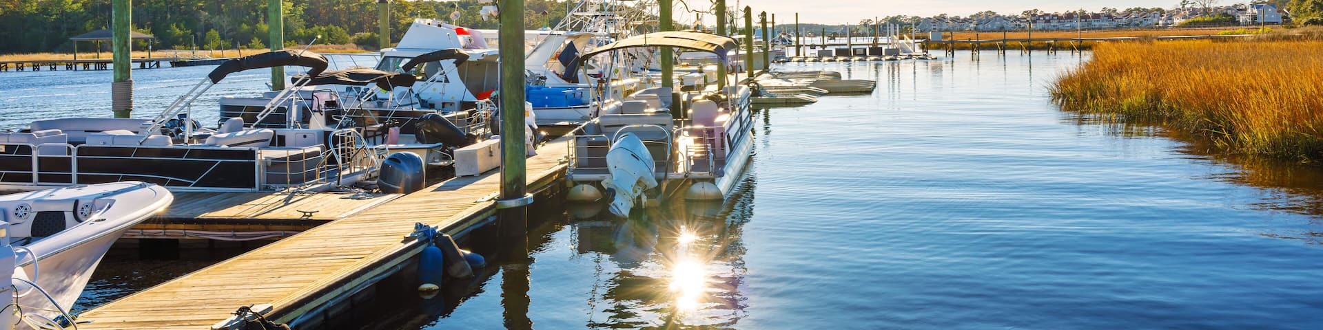 Wooden docks with fishing boats along the Intracoastal Waterway at the small town of Little River, South Carolina, in the Myrtle Beach area along the Atlantic Coast.
