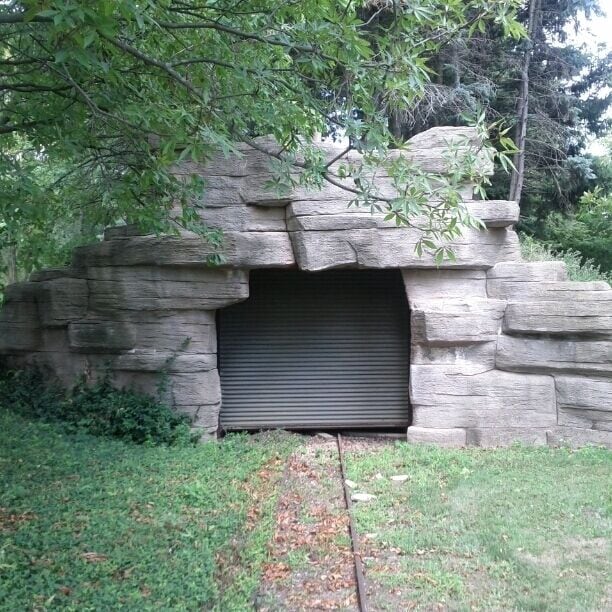 An abandoned kiddie railroad tunnel and tracks behind Par King Skill Golf.