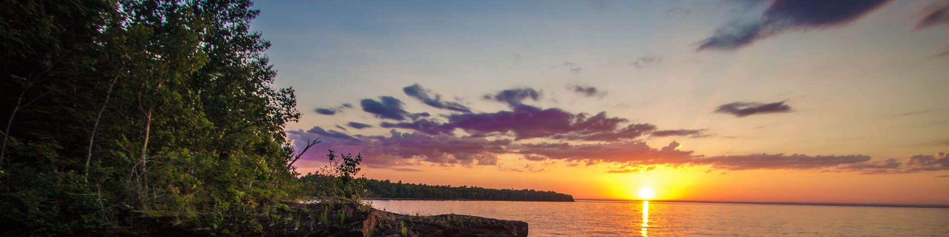Sunset On The Shores Of Lake Superior. Sunset on the shores of Lake Superior outside of L'Anse Michigan at the Point Abbaye Nature Sanctuary.