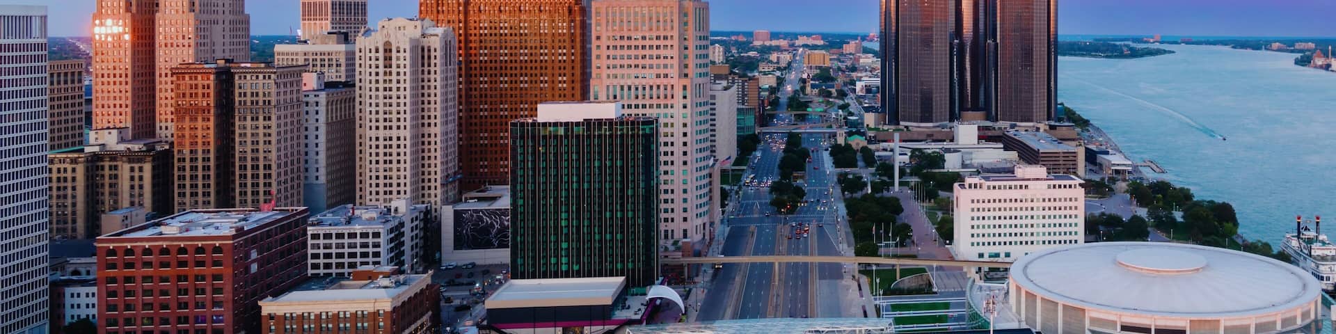 Detroit skyline at dawn, showcasing iconic skyscrapers and the Detroit River. Urban landscape. DOWNTOWN, DETROIT, MICHIGAN, UNITED STATES