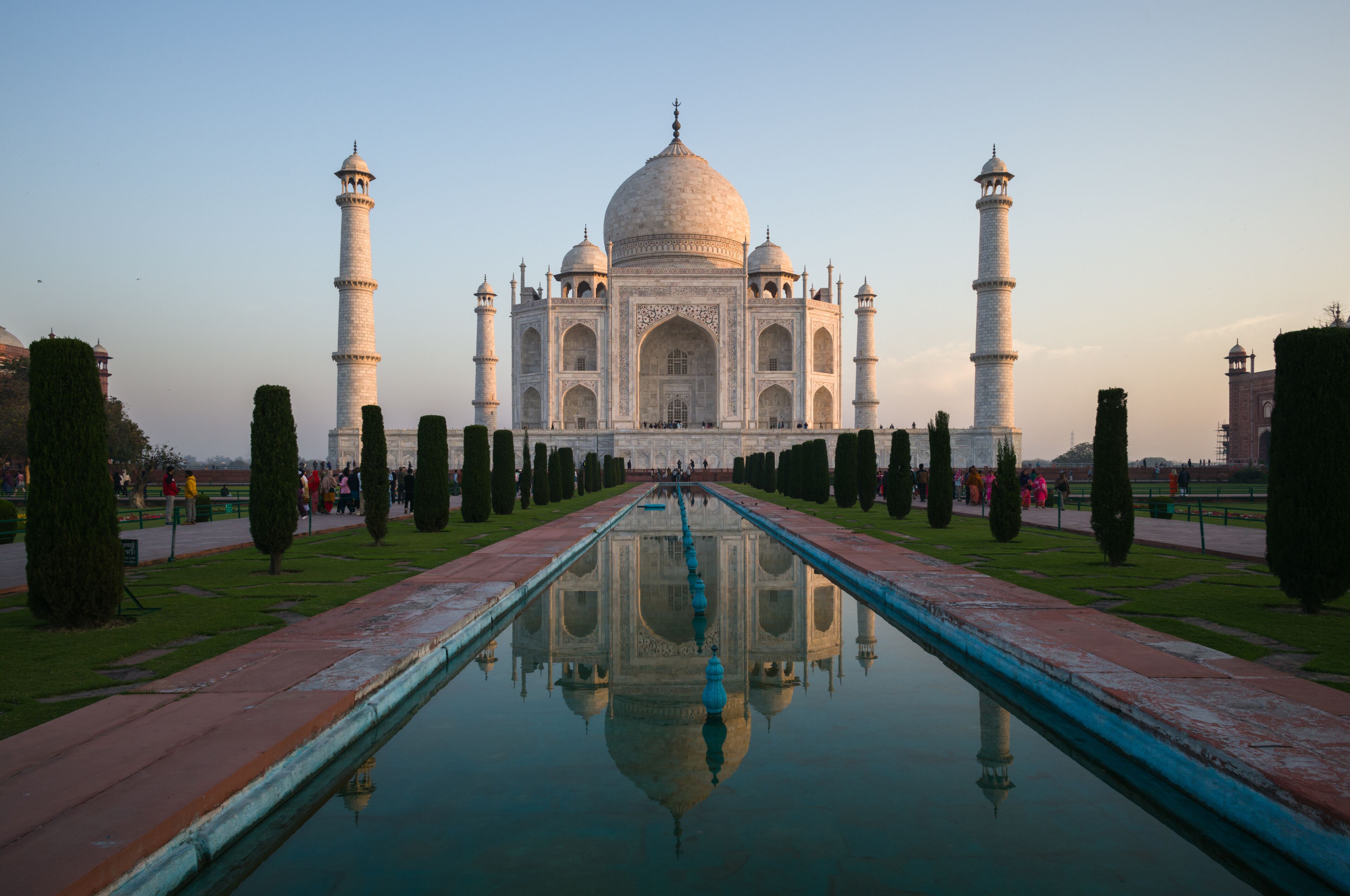 Taj Mahal mausoleum at sunrise reflected in water, Agra, India