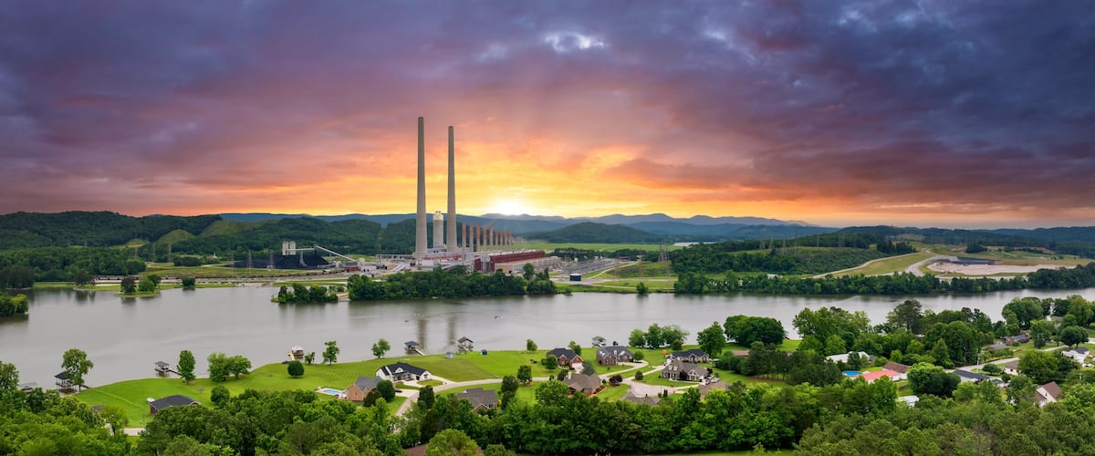 Suburban houses in residential neighborhood near Kingston Steam Plant in Roane County, Tennessee. Major coal-fired power plant producing electricity. Fossil fuel usage for energy production