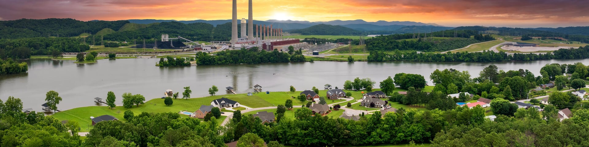 Suburban houses in residential neighborhood near Kingston Steam Plant in Roane County, Tennessee. Major coal-fired power plant producing electricity. Fossil fuel usage for energy production