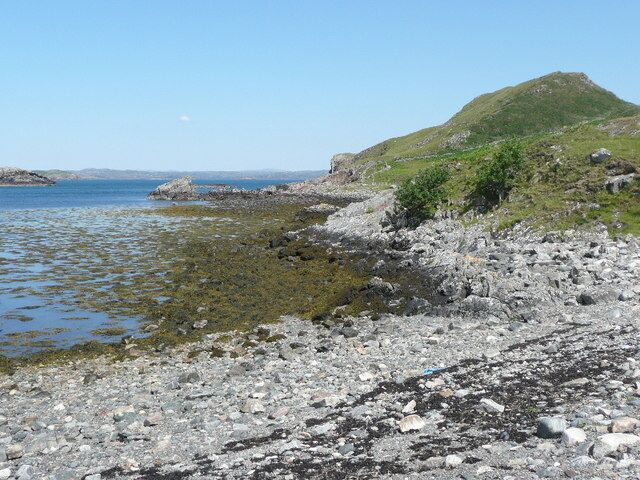 Low tide near the jetty at Culkein Drumbeg Meall Dearg is the hill on the right.