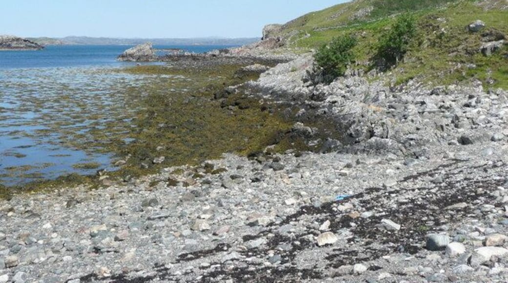 Low tide near the jetty at Culkein Drumbeg Meall Dearg is the hill on the right.