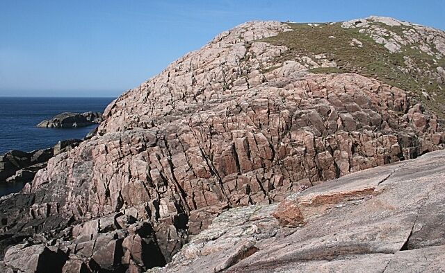 Fractured Granite These rocks are ancient granites, intruded into the Lewisian Gneiss some 1700 million years ago. They are fractured and jointed, and their surfaces have been ground smooth by the passage of glaciers during various ice ages.